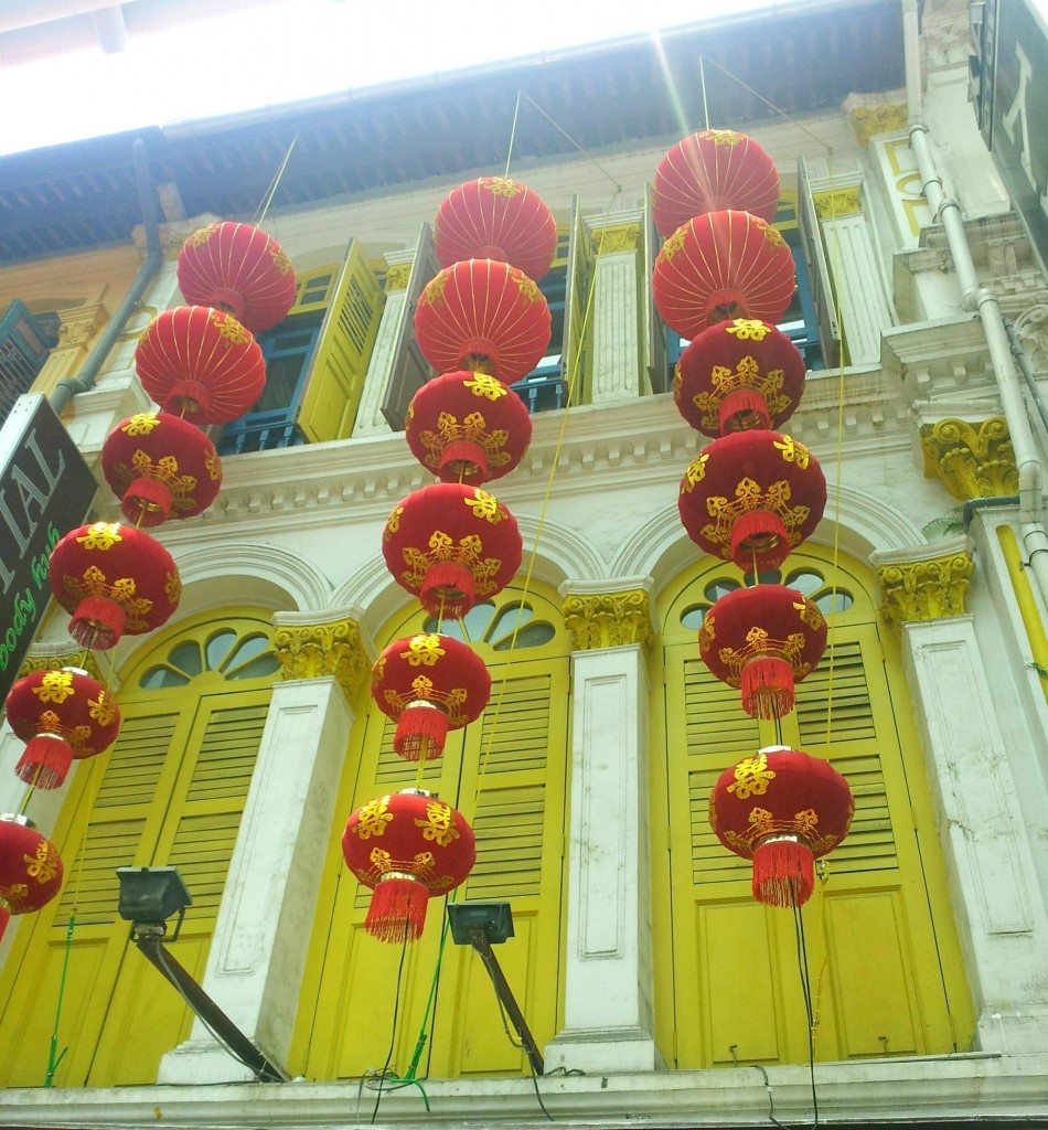 Red lanterns and colourful, restored shopfronts in China town, Singapore