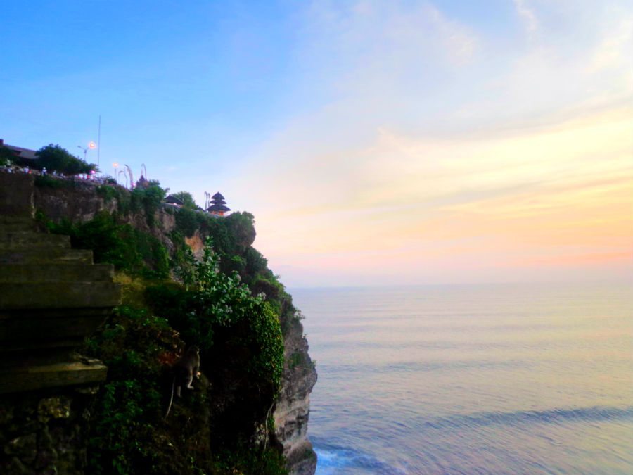 Image of crashing waves and sunset at Ulu Watu temple, Bali