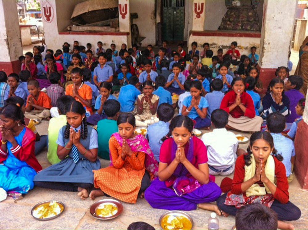 children praying at school