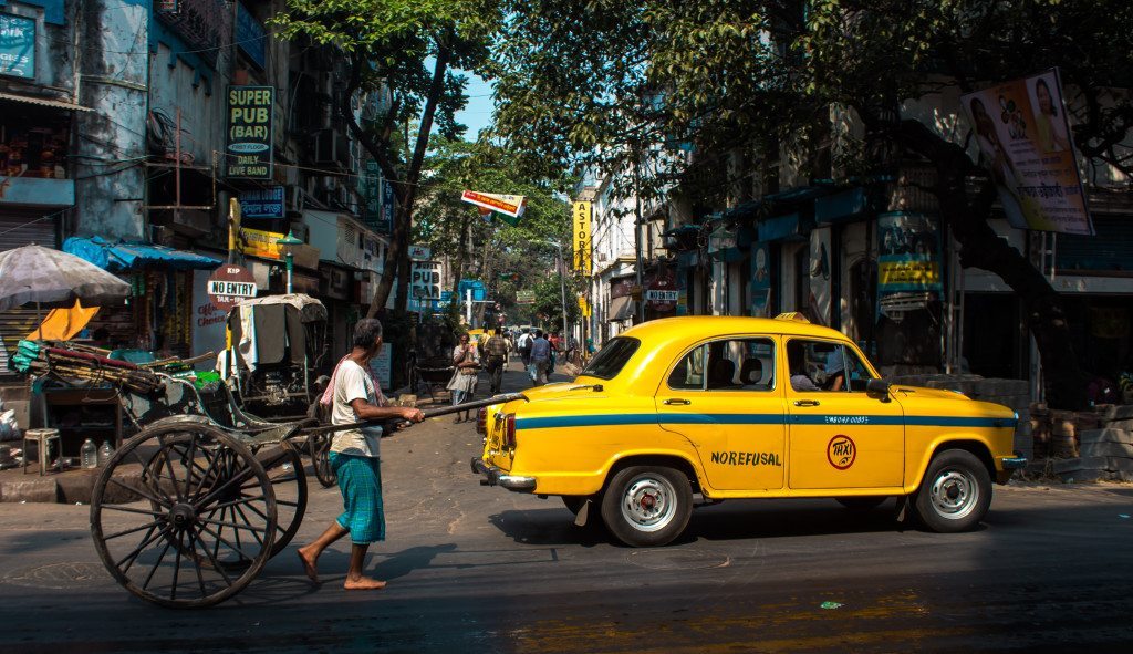 hand rickshaw and yellow cab calcutta kolkata