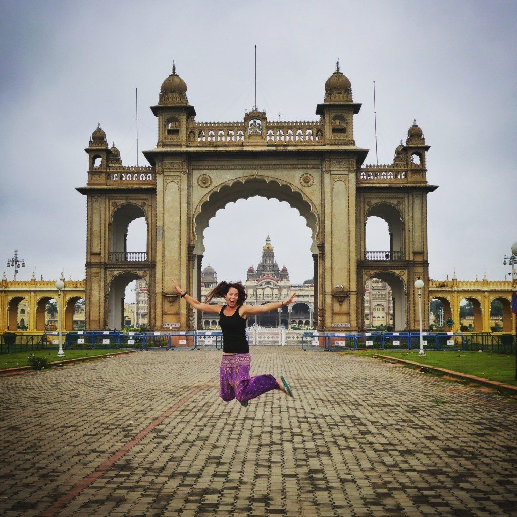 backpacking India jumping outside the elaborate Mysore Palace
