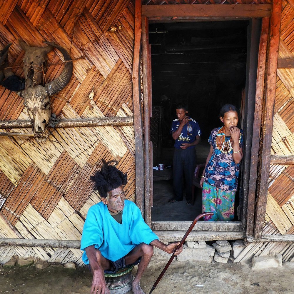 Konyak people outside their traditional houses