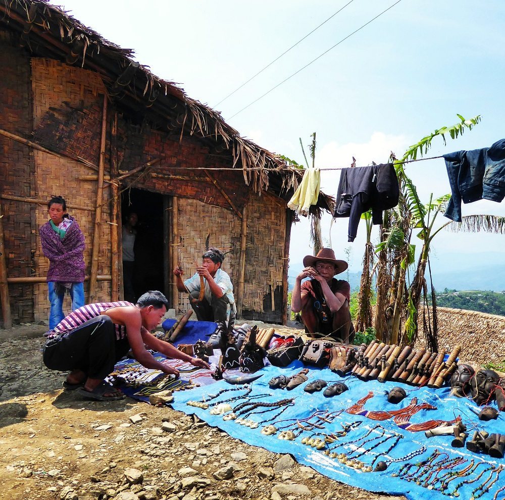 Tribal jewellery and opium pipes for sale outside the King's house in Longwa, Nagaland