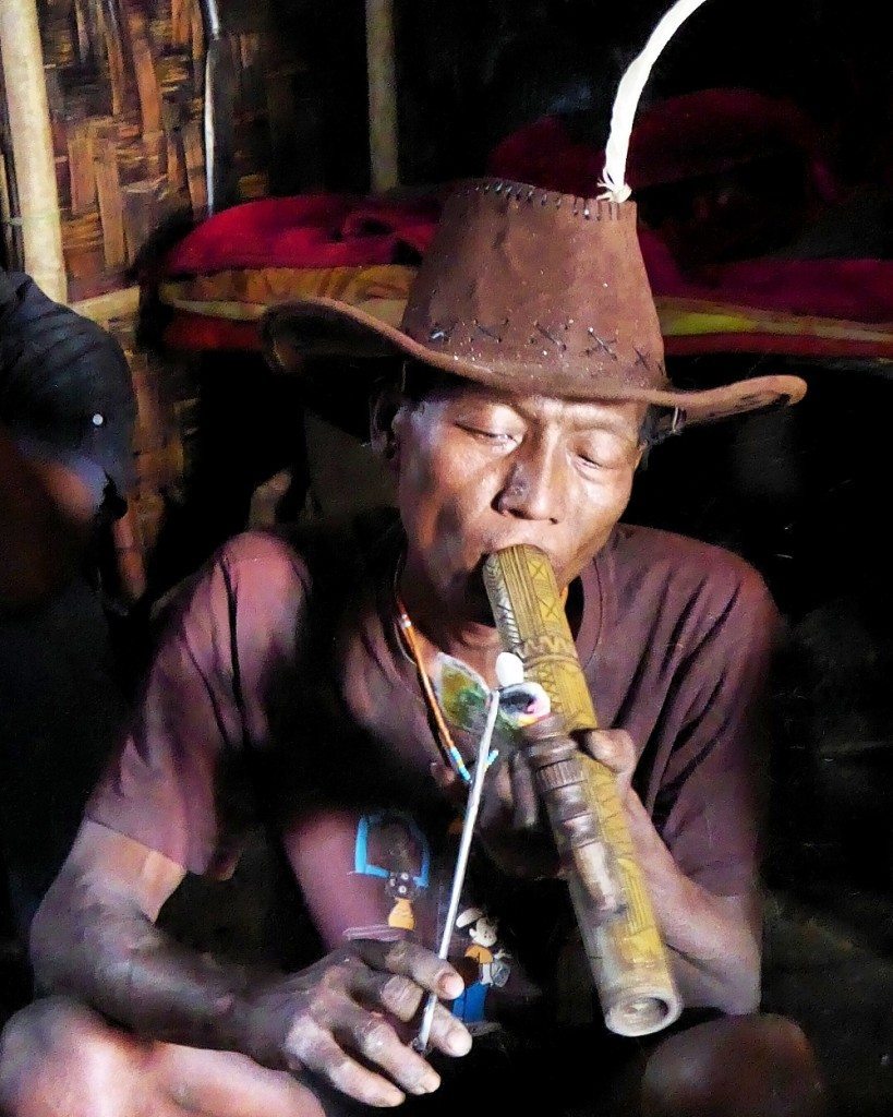 Smoking opium in the King's hut in Longwa