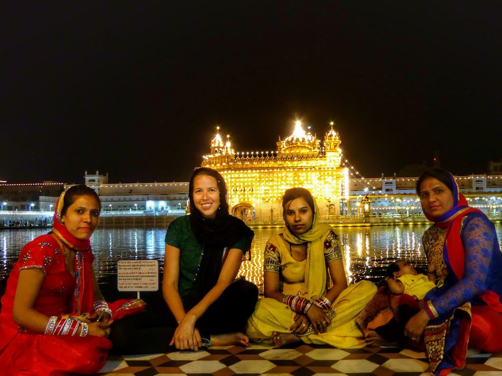women at golden temple at night
