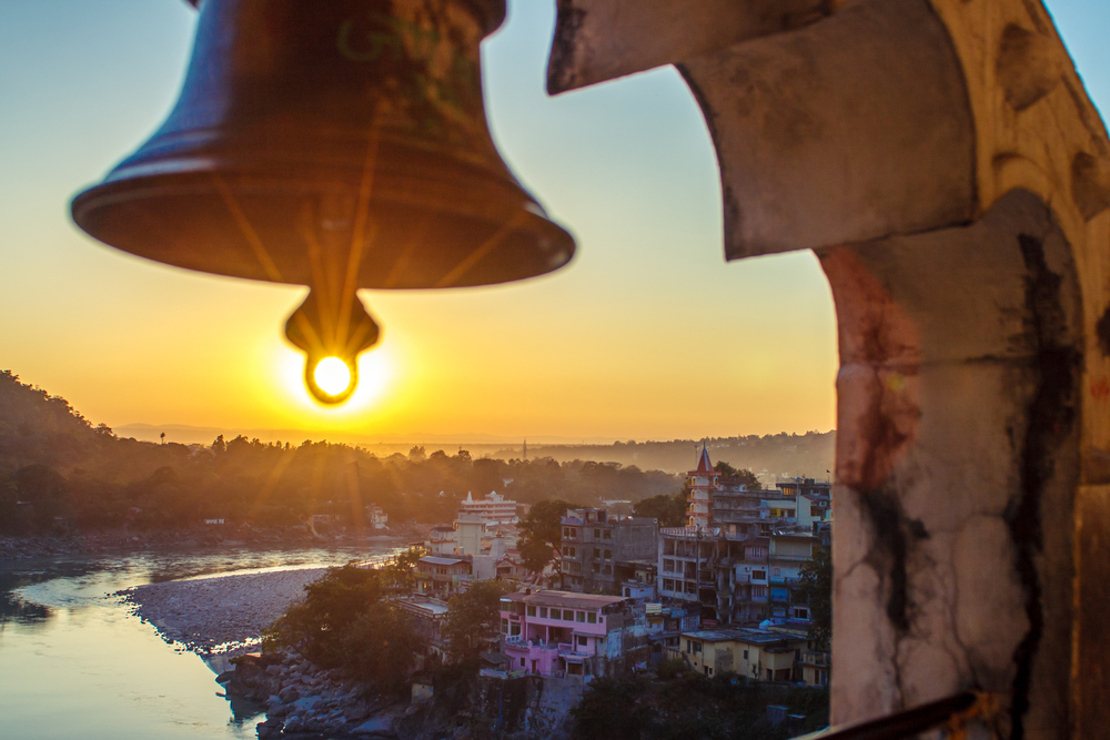 Temple bell at sunset in Rishikesh. Photo by Iurii Marchuk and Shutterstock