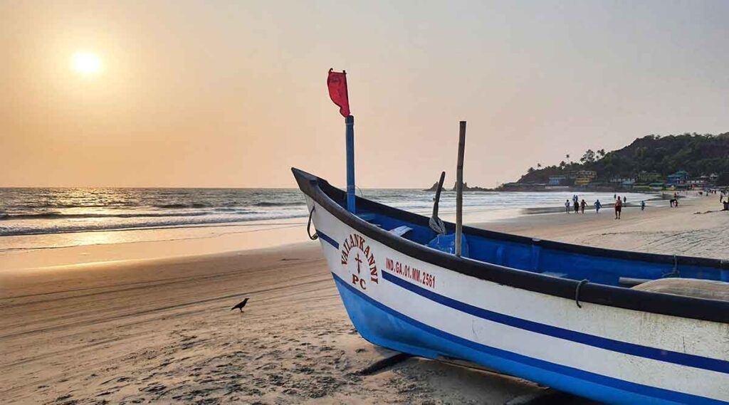 boats on goa beach at sunset - the ultimate insiders goa travel guide