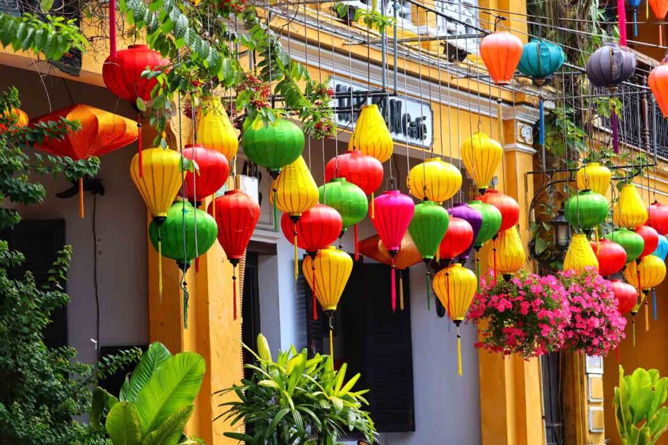 Yellow house with colorful lanterns outside in Hoi An, Vietnam