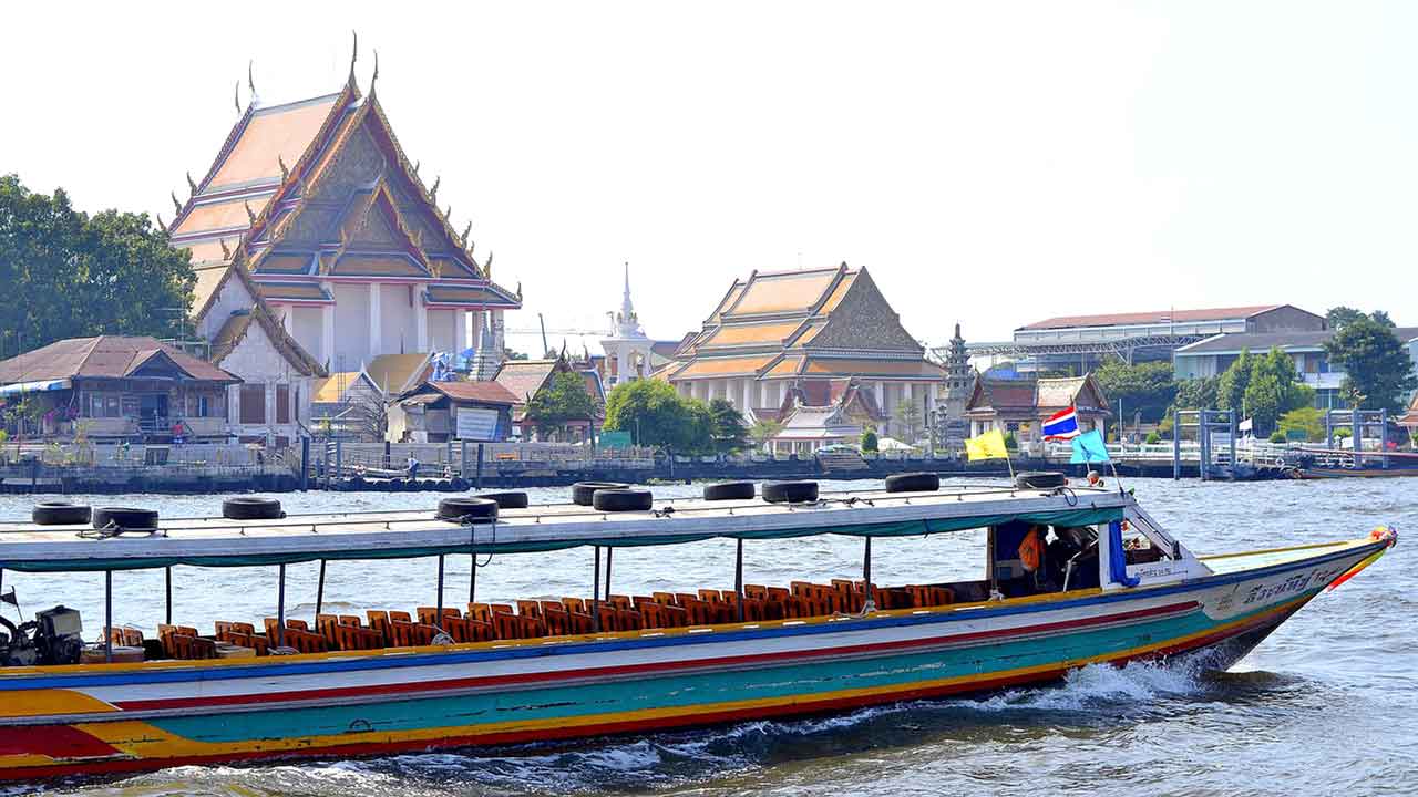 river temple and boat in Bangkok