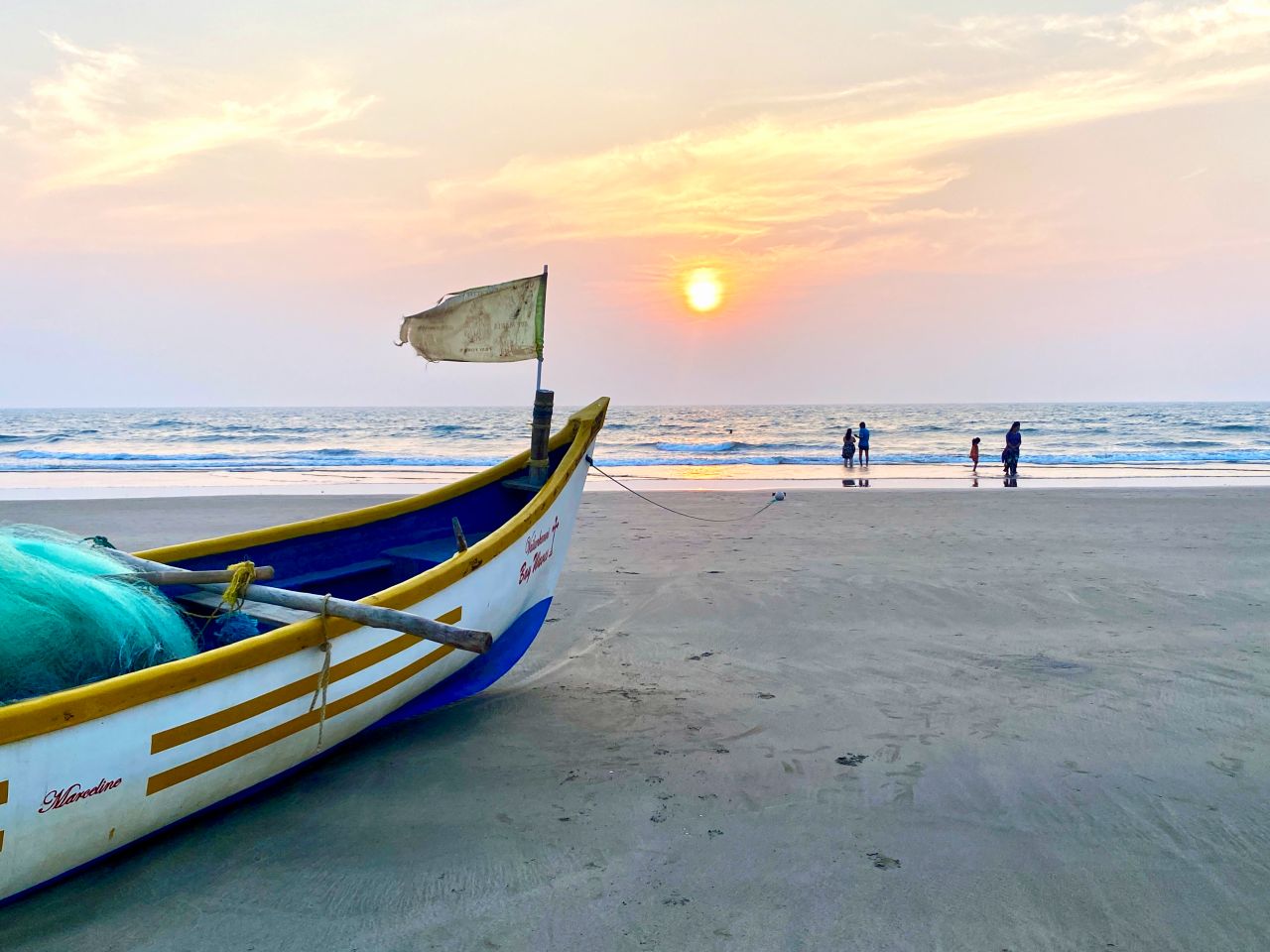 boat at sunset on the beach in goa india